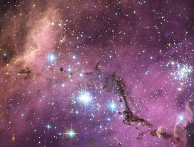 This image obtained from NASA on January 24, 2013 shows nearly 200, 000 light-years from Earth, the Large Magellanic Cloud, a satellite galaxy of the Milky Way, as it floats in space, around our galaxy. As the Milky Way‚Äôs gravity gently tugs on its neighbour‚Äôs gas clouds, they collapse to form new stars. In turn, these light up the gas clouds in a kaleidoscope of colours, visible in this image from the NASA/ESA Hubble Space Telescope. The Large Magellanic Cloud (LMC) is ablaze with star-forming regions. From the Tarantula Nebula, the brightest stellar nursery in our cosmic neighborhood, to LHA 120-N 11, part of which is featured in this Hubble image, the small and irregular galaxy is scattered with glowing nebulae, the most noticeable sign that new stars are being born. /Getty Images